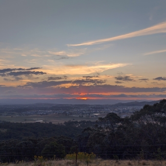 Sunset Embers, Little Mulligans, Bonner, with the setting sub hidden by two thin layers of cloud which are allowing the sun to shoot rays upwards