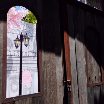 Lantern Waste, The Grounds of Alexandria, with an old-fashioned street-lamp visible through a wooden window