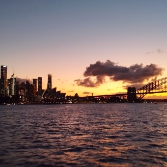 City Sunset, Sydney Harbour, with a glowing sunset between Sydney Harbour Bridge and Opera House reflected in the waters of Sydney Harbour