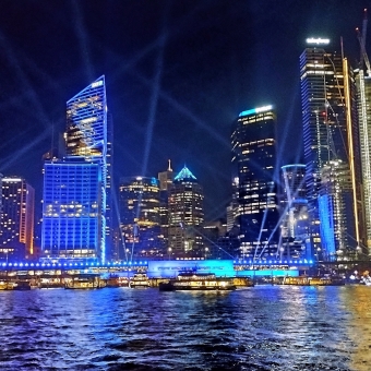 Lights Over The Water, Circular Quay, with beams of light over a blue-tinted city