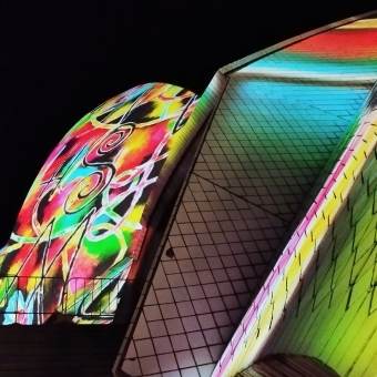 Close-Up Opera House, Bennelong Point, with intricate multi-coloured patterns against the Opera House which is in arms reach