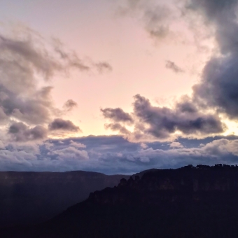 Sublime Sunset, Sublime Point Lookout, Leura, with mashed-potato clouds emblazoned with colour ranging from peach through orange to coral, with the Three Sisters silhouetted in the distance