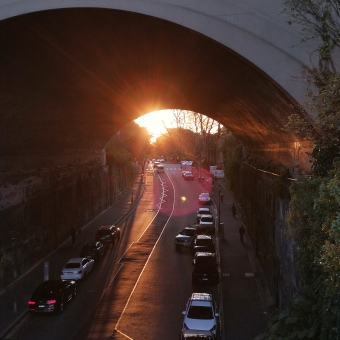 Barangaroo's Bridge, from Sydney Harbour Bridge, with the buildings of Barangaroo sandwiched between the Cahill Expressway and a pink sunset in the sky