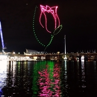The Geometrical City, from Sydney Harbour Bridge, with the picture divided into four quadrants of dusk sky and semi-lit buildings and footpath and busy road