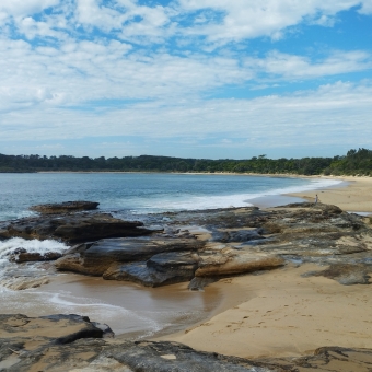 Serenity, Jibbon Beach, Bundeena, with an arced beach stretching out into the distance