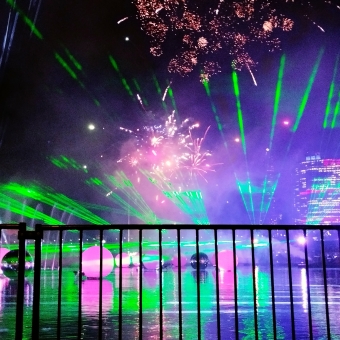 Lasers Lights & Fireworks, Darling Harbour, with magenta-coloured fireworks against green lasers sprawled across the sky